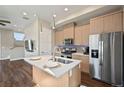 Bright kitchen with stainless steel appliances, a center island, and modern cabinetry at 1530 Terry St, Longmont, CO 80501