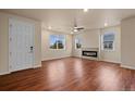 Bright living room features a modern fireplace, beautiful hardwood floors, and large windows at 152 Ambrose St, Erie, CO 80516