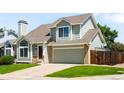 Charming exterior view of a two story home with a well kept lawn and attached two car garage at 20389 E Powers Pl, Centennial, CO 80015