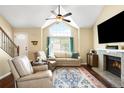 Bright living room with vaulted ceilings, large windows, fireplace, hardwood floors, and neutral decor at 20389 E Powers Pl, Centennial, CO 80015