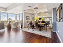 Elegant dining room with ample seating, hardwood floors, and a large mirrored wall at 1900 E Girard Pl # 907, Englewood, CO 80113