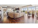 Open living room showcasing hardwood floors and a wall of windows with stunning views at 1900 E Girard Pl # 907, Englewood, CO 80113
