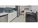 Updated kitchen featuring stainless steel appliances, breakfast bar and view of the living room at 500 S Pennsylvania St # 520, Denver, CO 80209