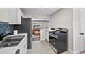 A modern kitchen featuring stainless steel appliances with open view to the stylish living room at 500 S Pennsylvania St # 520, Denver, CO 80209