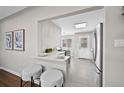 The kitchen features an open design with modern appliances and a bar area with seating at 500 S Pennsylvania St # 520, Denver, CO 80209