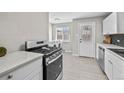 Bright kitchen with a modern gas range, stainless steel appliances, and easy access to laundry at 500 S Pennsylvania St # 520, Denver, CO 80209