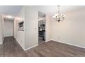 Bright dining area with hardwood floors and a stylish chandelier at 3600 S Pierce St # 5-101, Denver, CO 80235