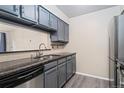 Stylish kitchen showcasing stainless steel appliances and grey painted cabinets at 3600 S Pierce St # 5-101, Denver, CO 80235