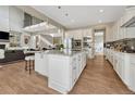 Spacious kitchen with a large center island, stainless steel appliances, and bright white cabinets at 11821 Discovery Ln, Parker, CO 80138