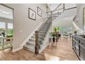 Elegant staircase with wrought iron railings, hardwood floors, and abundant natural light at 11821 Discovery Ln, Parker, CO 80138