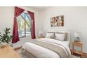 Bright bedroom with a queen bed, window, and wood flooring at 561 Cherokee St, Denver, CO 80204