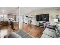 Open concept kitchen and living room with hardwood floors at 11914 Bellaire Cir, Thornton, CO 80233