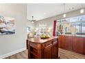 Open concept kitchen with an island counter that looks into living room area at 5401 S Park Terrace Ave # 105A, Greenwood Village, CO 80111