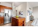 Kitchen with stainless steel refrigerator and moveable center island at 5401 S Park Terrace Ave # 105A, Greenwood Village, CO 80111