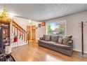 Spacious living room with a large window, comfortable sofa, and elegant decor for relaxing and entertaining at 15628 E Girard Pl, Aurora, CO 80013