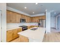 Eat-in kitchen with stainless steel appliances, island, and bright countertops at 21292 E 63Rd Dr, Aurora, CO 80019