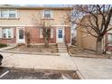 Charming brick and siding townhome with inviting front entrance and well-maintained landscaping at 1545 S Ouray Cir # A, Aurora, CO 80017