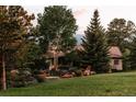 Beautifully landscaped yard surrounds a well-maintained home with a red tile roof at 1621 Baneberry Ln, Golden, CO 80401