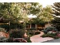 A stone path leads to this home with lush landscaping and an inviting entryway at 1621 Baneberry Ln, Golden, CO 80401