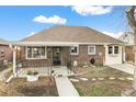 Charming brick home with a well-maintained front yard and covered entry at 875 S Dale Ct, Denver, CO 80219