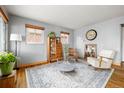 Bright living room featuring hardwood floors, large windows, and a neutral color palette at 875 S Dale Ct, Denver, CO 80219