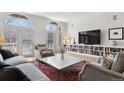 Spacious living room with large windows, built-in shelving, and comfortable seating arrangement at 301 Garfield St # 1E, Denver, CO 80206