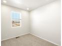 Cozy bedroom with carpet flooring, a window, and fresh white paint at 6068 Corral St, Brighton, CO 80601