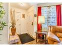 Well-lit foyer with a coat closet, wood floors, and a decorated console table at 12655 E Pacific Cir # E, Aurora, CO 80014