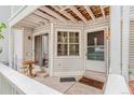 Cozy covered porch with seating, a doormat, and a glass sliding door at 12655 E Pacific Cir # E, Aurora, CO 80014