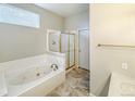 Clean bathroom with a soaking tub and a separate shower at 9806 Hooker Ct, Denver, CO 80031