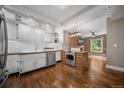 Well-lit kitchen with white cabinets, butcher block countertops, stainless steel appliances, and an island at 3254 Newton St, Denver, CO 80211