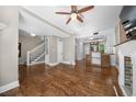 Open-concept living space with hardwood floors, white trim, and access to the kitchen and staircase at 3254 Newton St, Denver, CO 80211