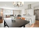 Inviting open concept showcases an island kitchen flowing into the living and dining area, perfect for modern living at 6163 W 76Th Ave, Arvada, CO 80003