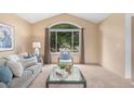 Sunlit living room with vaulted ceilings, a large window and neutral tones throughout at 10152 Telluride St, Littleton, CO 80125
