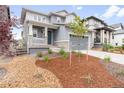 Beautiful two-story home features a manicured front yard with a cozy porch and a two-car garage at 8582 Cheraw St, Littleton, CO 80125