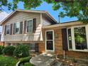 Exterior shot of a two-story home with brick accents and a well-maintained front yard at 4664 S Zang St, Morrison, CO 80465