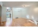 Bright living room with hardwood floors and modern lighting fixtures at 4664 S Zang St, Morrison, CO 80465