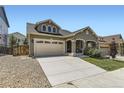 House exterior with a two-car garage and gravel driveway at 1505 Raindrop Way, Castle Rock, CO 80109