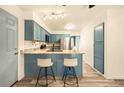 Well-lit kitchen with a center island, modern appliances, and ample counter space at 12234 W Saratoga Ave, Morrison, CO 80465