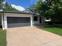 Well-maintained painted brick home with a spacious driveway and attached garage at 2836 S Fenton St, Denver, CO 80227