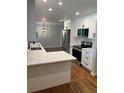 Bright kitchen with white cabinets, stainless steel appliances, and sleek countertops at 2836 S Fenton St, Denver, CO 80227