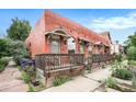 Charming multi-unit property with a shared wood porch and a unique red brick exterior with star accents at 474 N Inca St, Denver, CO 80204