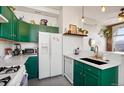 Bright kitchen features green cabinetry, white countertops, stainless steel appliances, and a modern sink at 474 N Inca St, Denver, CO 80204
