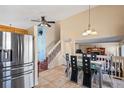 Open-concept kitchen flowing into the dining area, featuring stainless steel appliances and tile flooring at 4931 S Danube St, Aurora, CO 80015