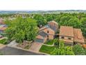 Scenic aerial shot of a charming home surrounded by lush greenery and mature trees at 10222 W Ida Ave # 237, Littleton, CO 80127