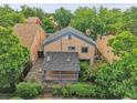 Overhead view of a home featuring a spacious deck and mature trees at 10222 W Ida Ave # 237, Littleton, CO 80127