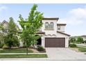 Charming two-story home with a well-maintained lawn, a brown garage door, and inviting curb appeal at 15205 W Baker Ave, Lakewood, CO 80228