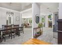 Open-concept living space features a dining area, living room with a fireplace, and neutral decor at 8677 S Buchanan Way, Aurora, CO 80016