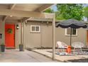 Home entrance with a bright red door adorned with a wreath, offering a welcoming appeal at 1831 S Ivanhoe St, Denver, CO 80224