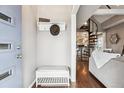 Stylish entryway showcasing a spiral staircase, hat rack, hardwood floors, and modern decor for an elegant welcome at 1194 S Washington St, Denver, CO 80210
